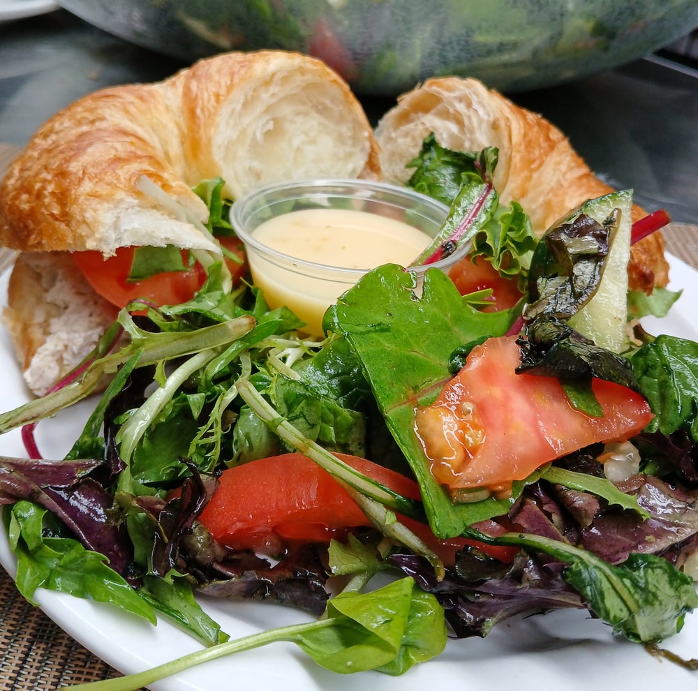 Leisure Vale Glendale croissant sandwich with mixed greens and tomatoes