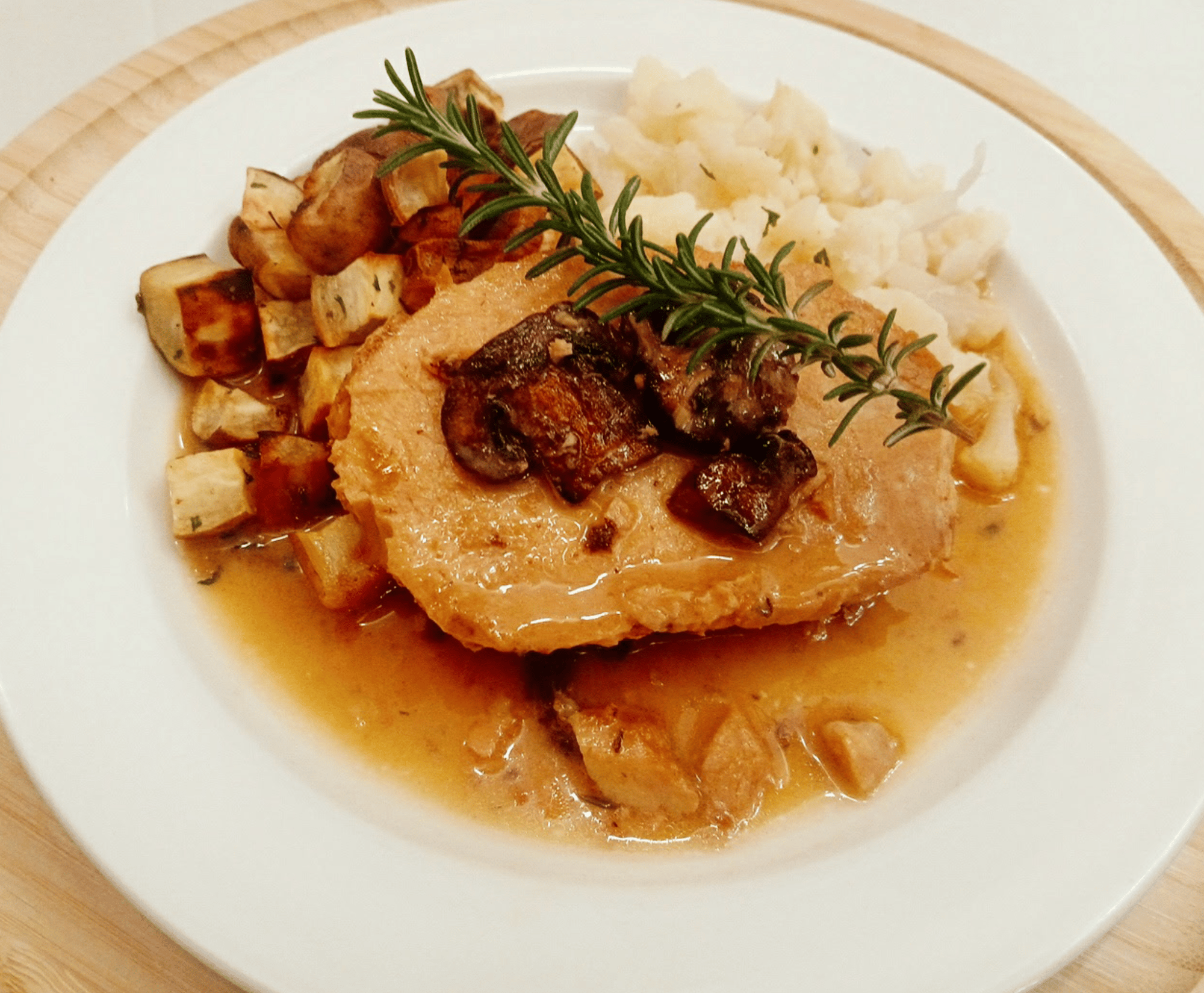 Sliced chicken with roasted and mashed potatoes in savory brown sauce, prepared by the Leisure Vale culinary team